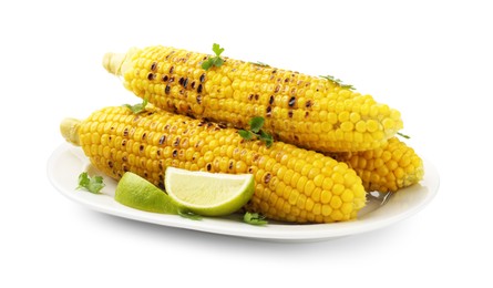 Photo of Tasty grilled corncobs with parsley and lime slices isolated on white