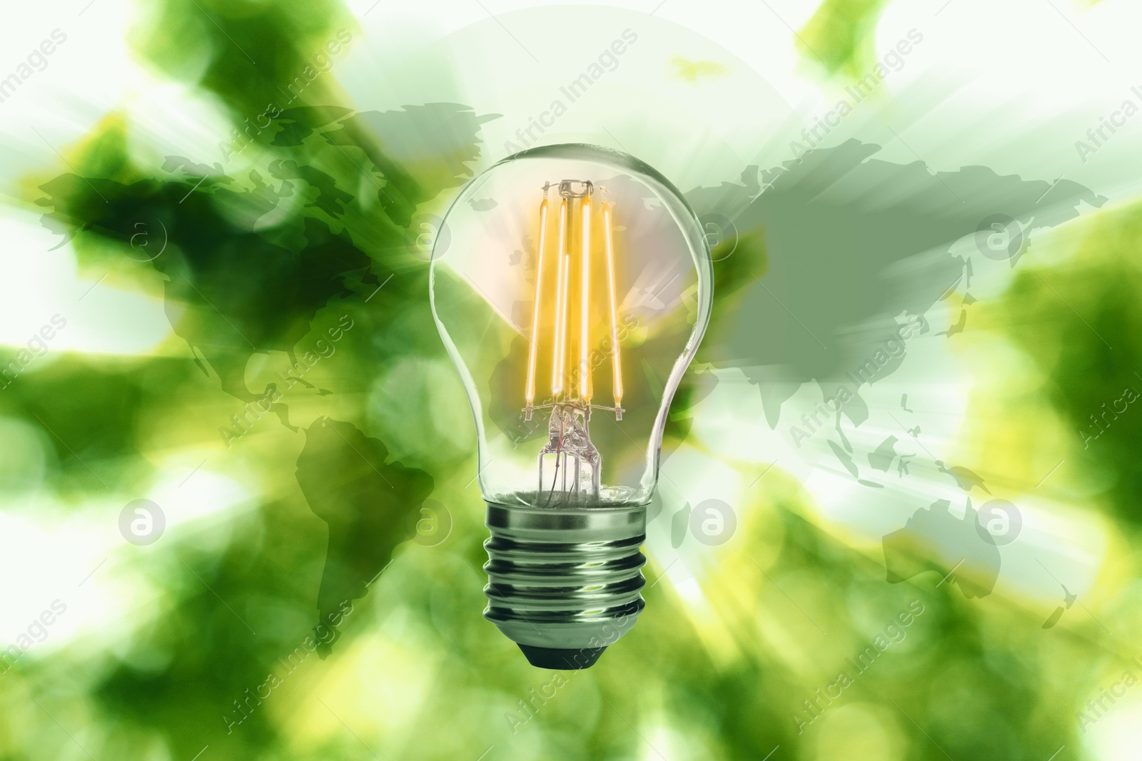 Electricity and nature. Glowing light bulb and world map against blurred green background Image of Electricity and nature. Glowing light bulb and world map against blurred green background