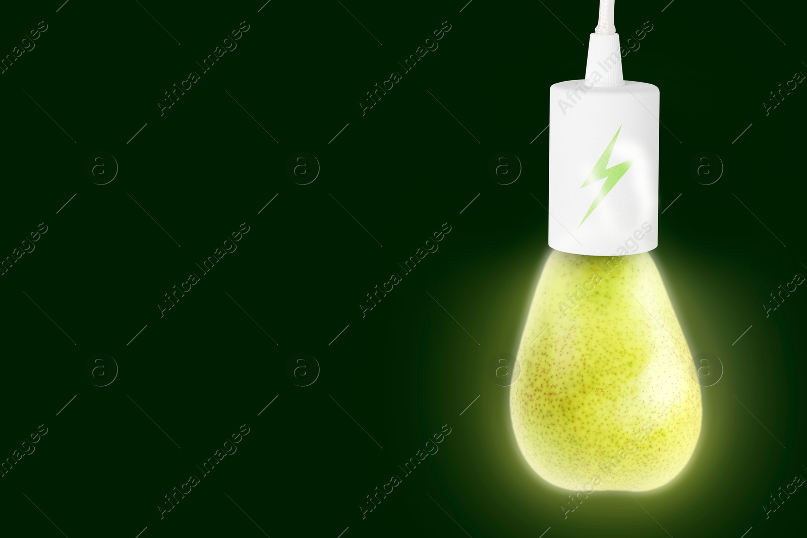Electricity and nature. Pear as glowing light bulb with lightning symbol against dark green background. Space for text Image of Electricity and nature. Pear as glowing light bulb with lightning symbol against dark green background. Space for text