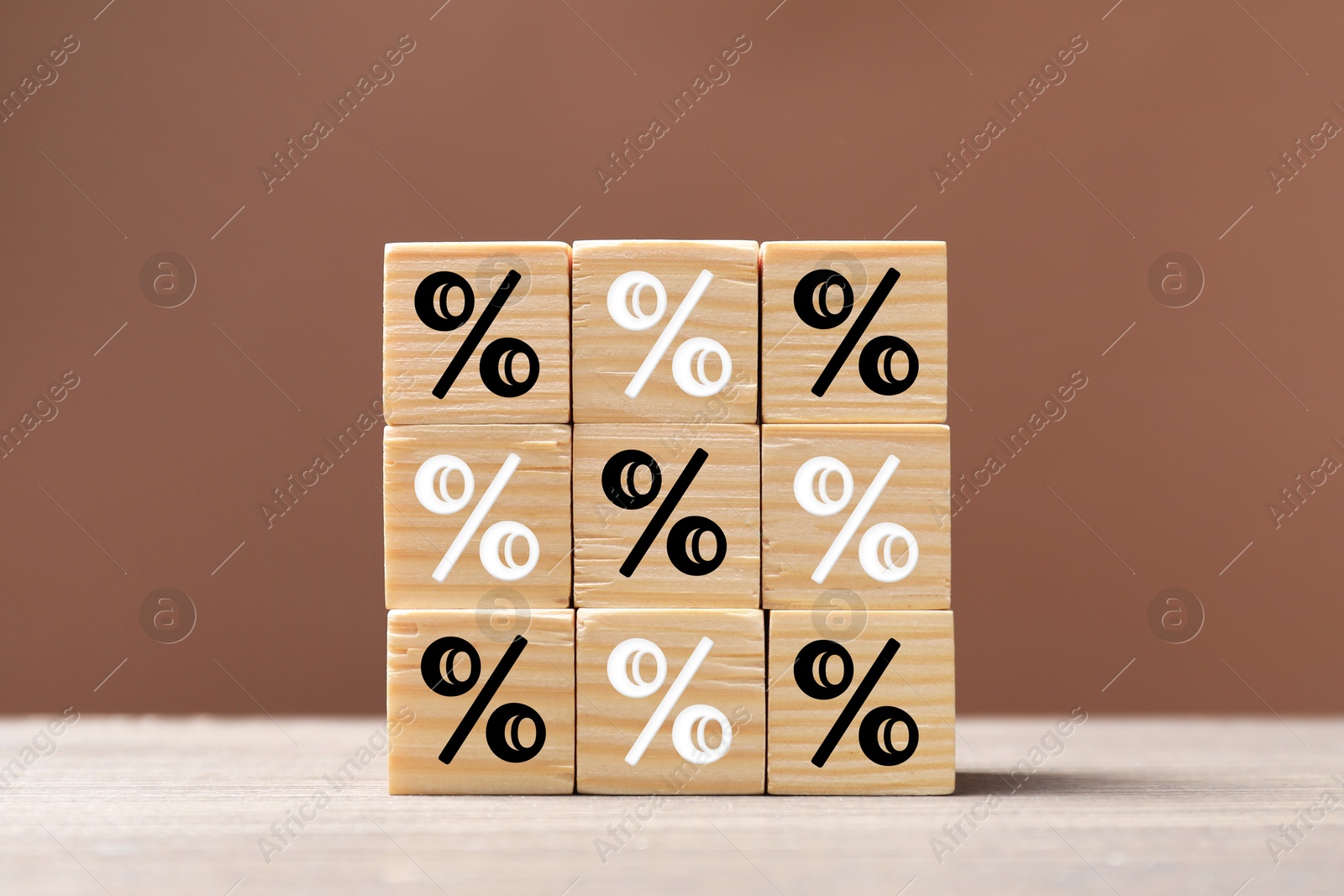 Percent signs on wooden cubes against brown background Image of Percent signs on wooden cubes against brown background