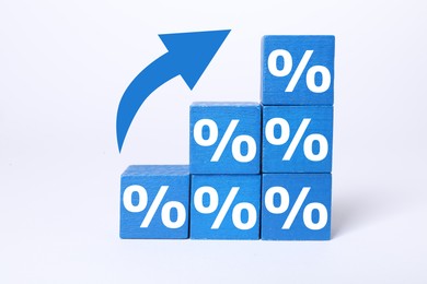 Image of Percent signs on blue cubes and arrow against white background