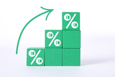 Image of Percent signs on green cubes and arrow against white background