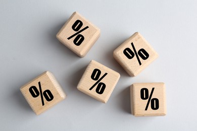 Image of Wooden cubes with percent signs on grey background, top view