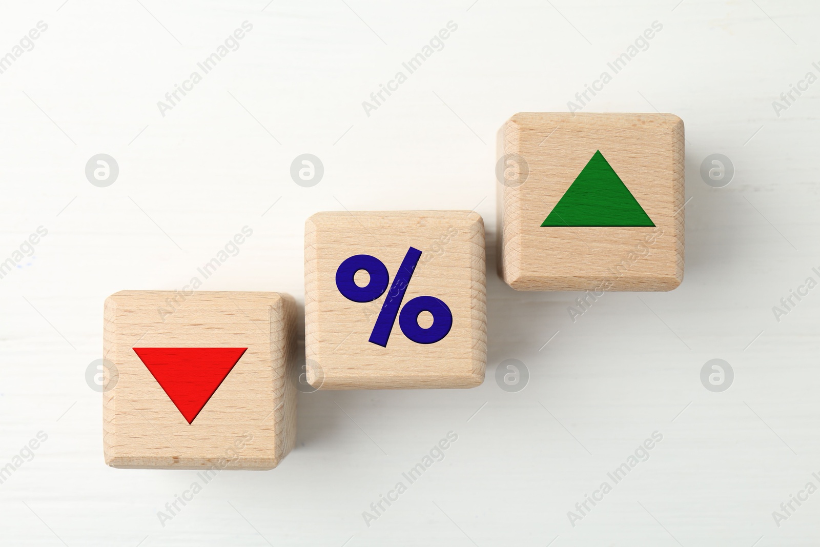 Wooden cubes with percent sign, up and down arrows on white background, top view Image of Wooden cubes with percent sign, up and down arrows on white background, top view