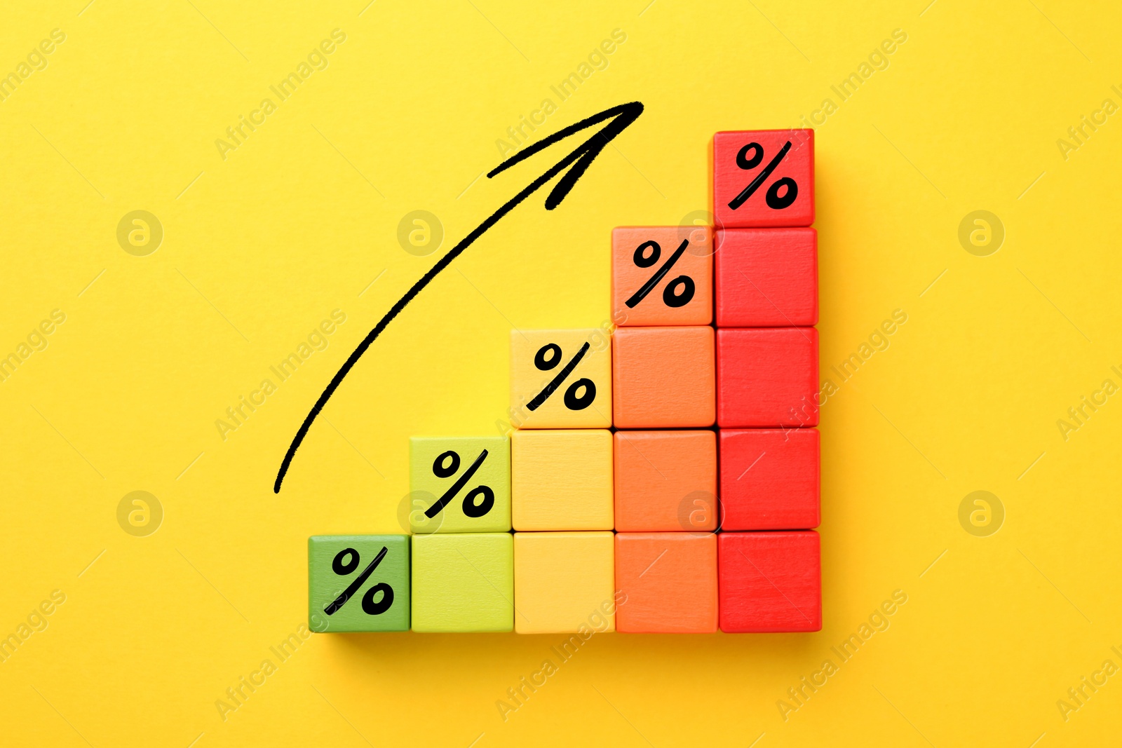 Image of Colorful cubes with percent signs and arrow on orange background, top view