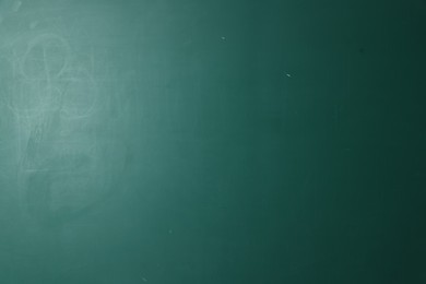 Photo of Blank green chalkboard as background, closeup view