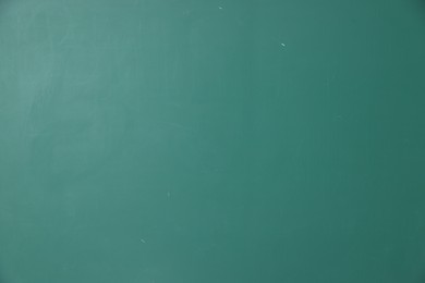Photo of Blank green chalkboard as background, closeup view