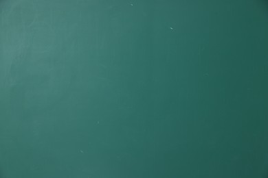 Photo of Blank green chalkboard as background, closeup view