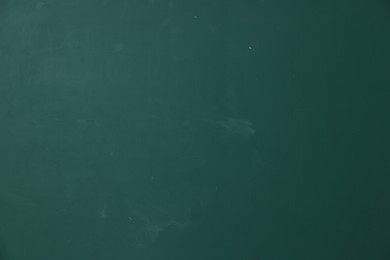 Photo of Blank green chalkboard as background, closeup view