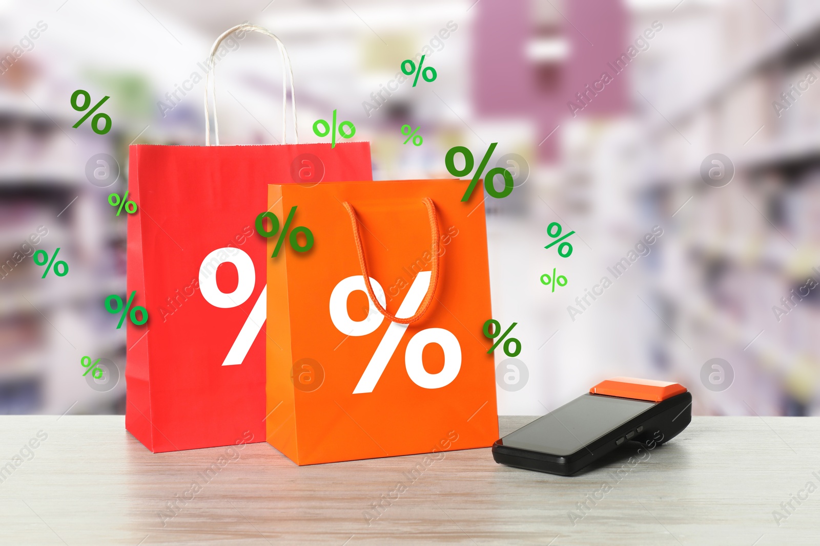 Shopping bags with percent signs and payment terminal on counter in store Image of Shopping bags with percent signs and payment terminal on counter in store