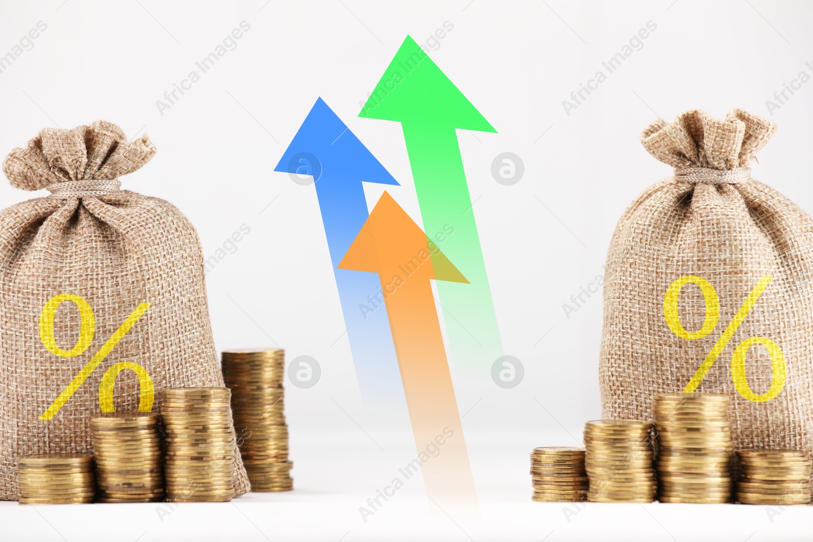 Burlap bags with percent signs, arrows and coins against white background Image of Burlap bags with percent signs, arrows and coins against white background
