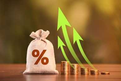 Image of Burlap bag with percent sign, arrows and coins against blurred background