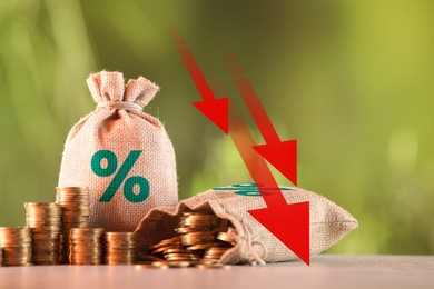 Image of Burlap bags with percent signs, arrows and coins against blurred background
