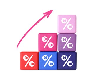Image of Percent signs on colorful cubes and arrow against white background