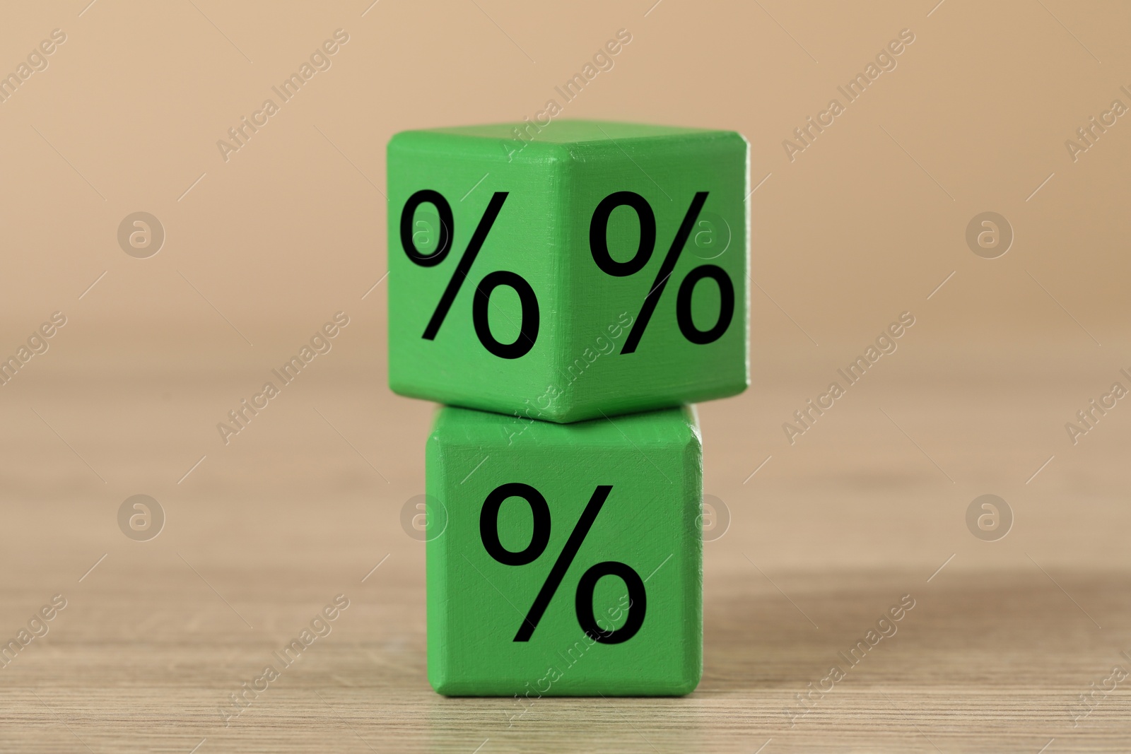 Image of Green cubes with percent signs on wooden table