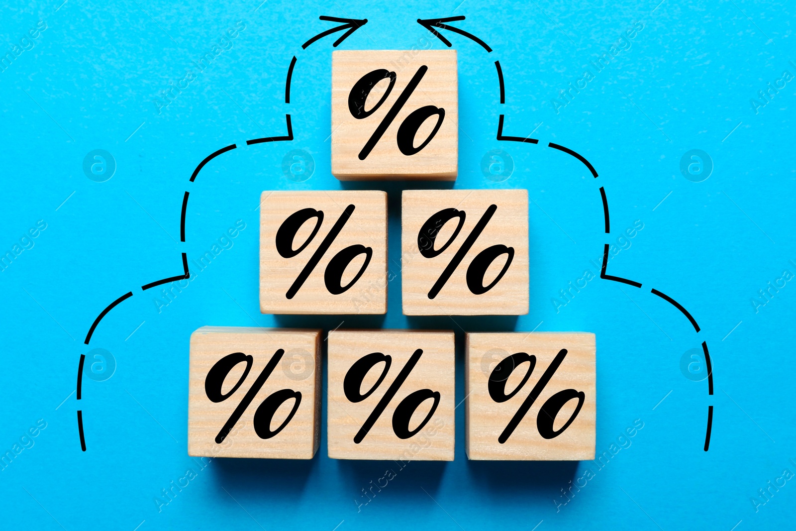 Image of Wooden cubes with percent signs and arrows on blue background, top view