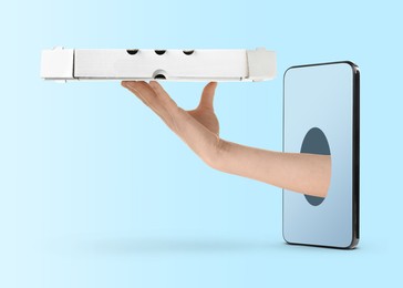 Image of Food ordering and delivery service. Woman's hand giving pizza box through mobile phone display, closeup. Light blue gradient background