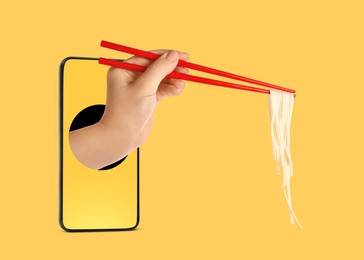 Image of Food ordering and delivery service. Woman's hand with tasty rice noodles, sticking out of mobile phone display against orange background, closeup