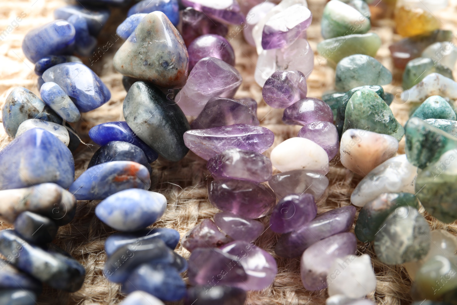 Many different healing stones on table, closeup Photo of Many different healing stones on table, closeup