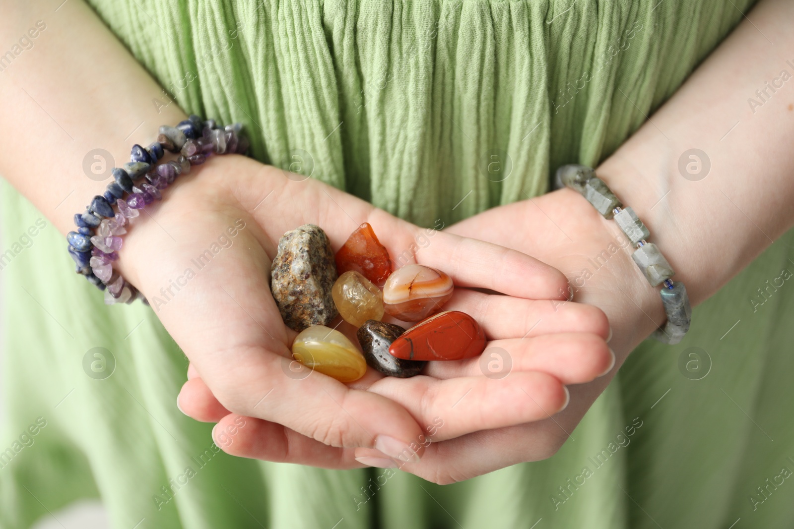 Photo of Woman with different beautiful healing stones, closeup