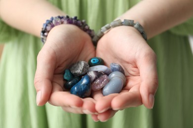 Photo of Woman with different beautiful healing stones, closeup