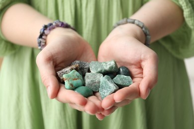Photo of Woman with different beautiful healing stones, closeup