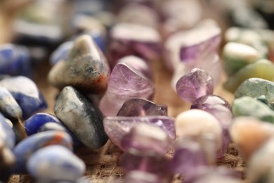 Photo of Many different healing stones on table, closeup