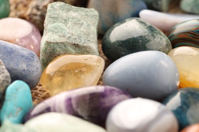 Photo of Different beautiful healing stones on table, closeup
