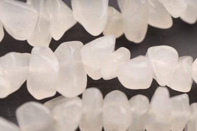 Photo of Beautiful healing stones on gray table, top view