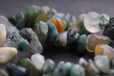 Photo of Many different healing stones on gray table, closeup
