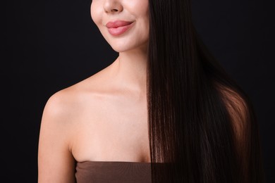 Photo of Woman with beautiful smooth hair after lamination procedure on black background, closeup