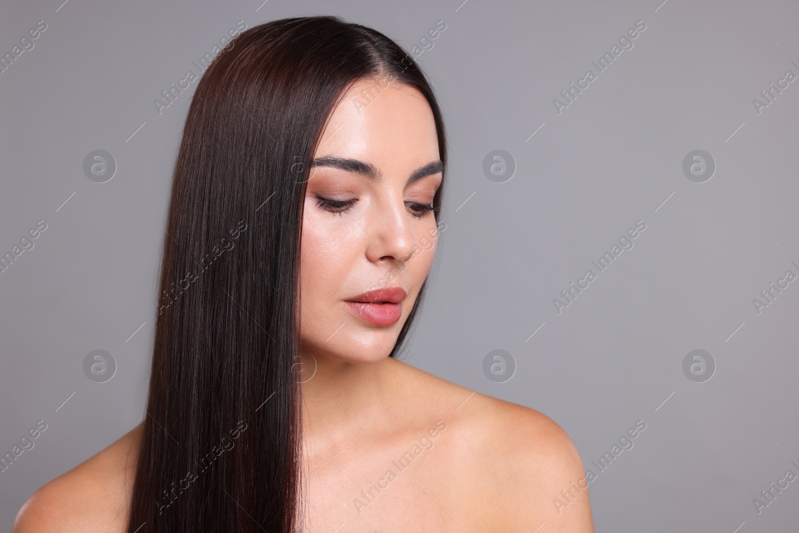 Photo of Woman with beautiful smooth hair after lamination procedure on light grey background, space for text