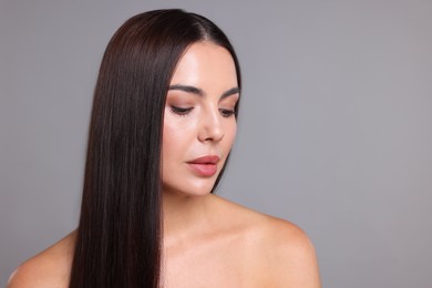 Photo of Woman with beautiful smooth hair after lamination procedure on light grey background, space for text