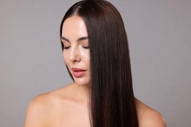 Photo of Woman with beautiful smooth hair after lamination procedure on light grey background
