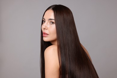 Photo of Woman with beautiful smooth hair after lamination procedure on light grey background