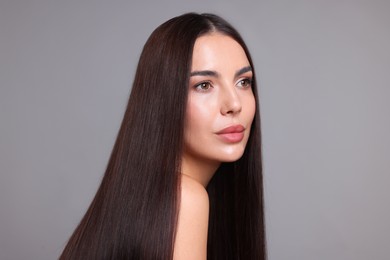Photo of Woman with beautiful smooth hair after lamination procedure on light grey background