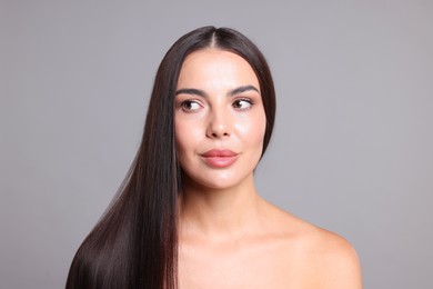 Photo of Woman with beautiful smooth hair after lamination procedure on light grey background