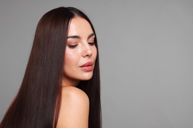 Photo of Woman with beautiful smooth hair after lamination procedure on light grey background, space for text