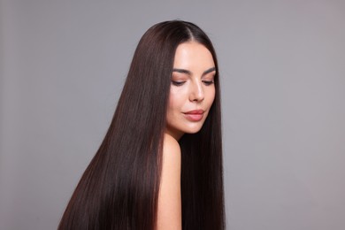 Photo of Woman with beautiful smooth hair after lamination procedure on light grey background