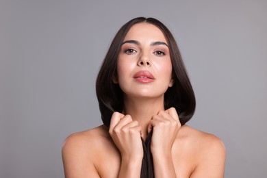 Photo of Woman with beautiful smooth hair after lamination procedure on light grey background