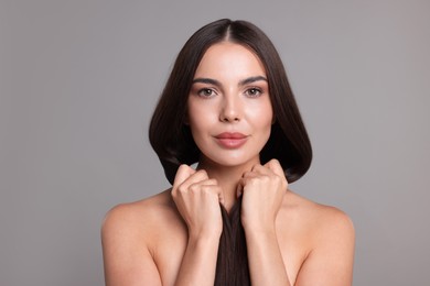 Photo of Woman with beautiful smooth hair after lamination procedure on light grey background