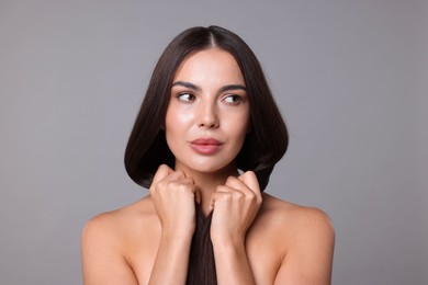 Photo of Woman with beautiful smooth hair after lamination procedure on light grey background