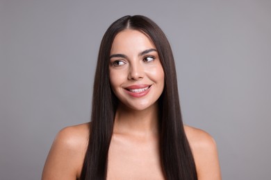 Photo of Woman with beautiful smooth hair after lamination procedure on light grey background