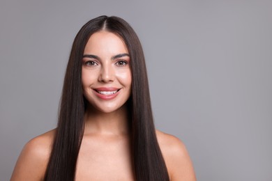 Photo of Woman with beautiful smooth hair after lamination procedure on light grey background, space for text