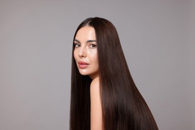 Photo of Woman with beautiful smooth hair after lamination procedure on light grey background