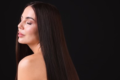 Photo of Woman with beautiful smooth hair after lamination procedure on black background, space for text