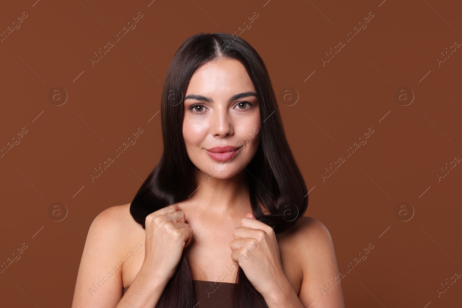 Woman with beautiful smooth hair after lamination procedure on brown background Photo of Woman with beautiful smooth hair after lamination procedure on brown background