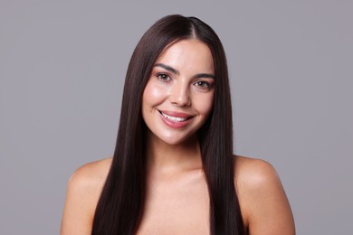 Photo of Woman with beautiful smooth hair after lamination procedure on light grey background
