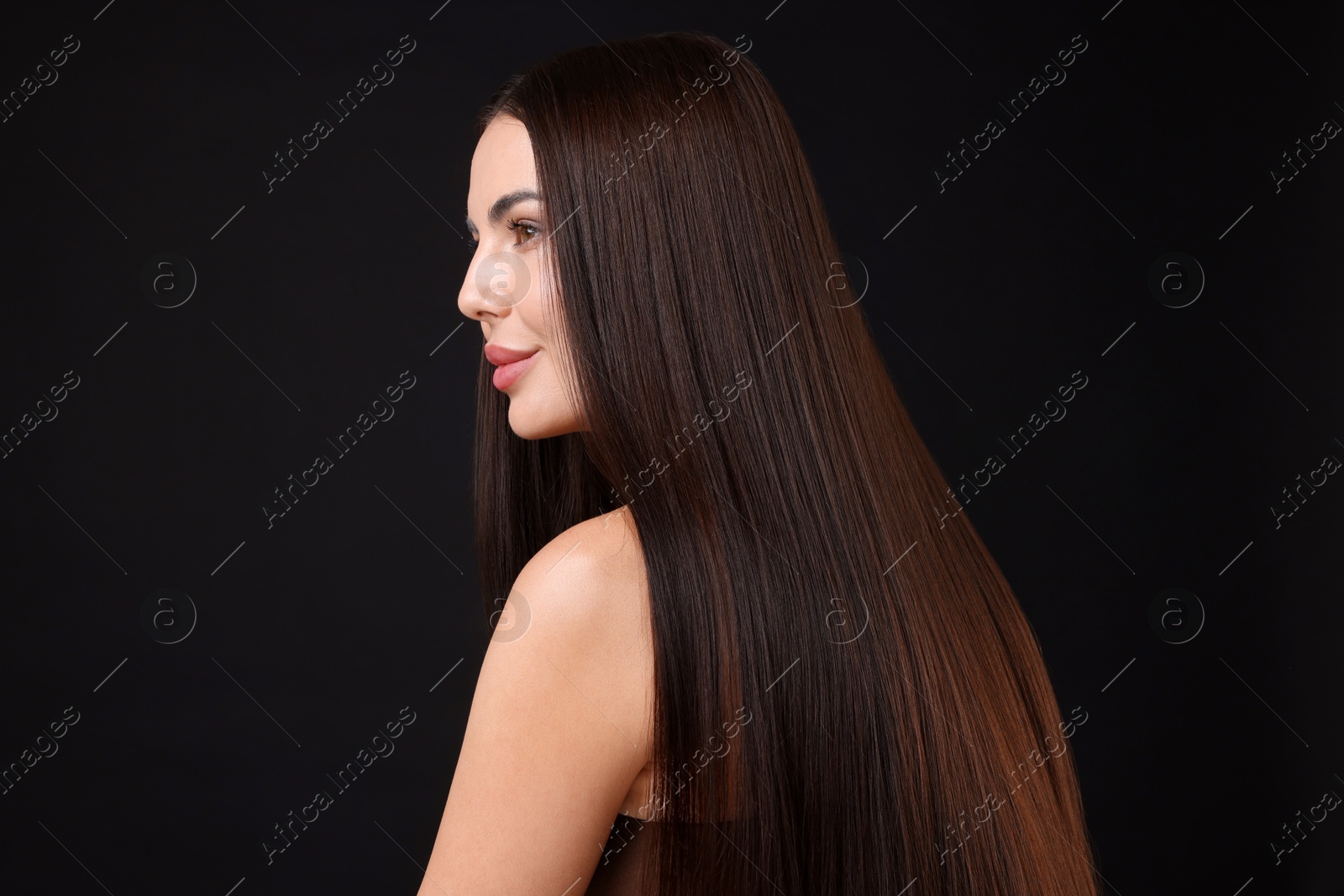 Photo of Woman with beautiful smooth hair after lamination procedure on black background