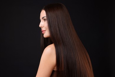 Photo of Woman with beautiful smooth hair after lamination procedure on black background